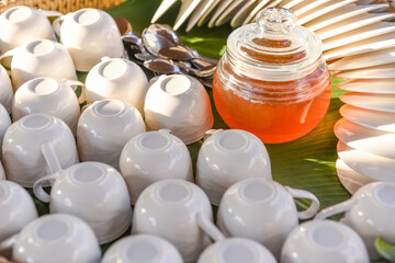 white cup for tea with honey jar.
