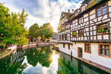 Quaint timbered houses of Petite France in Strasbourg, France. French traditional houses with sunrise flare 