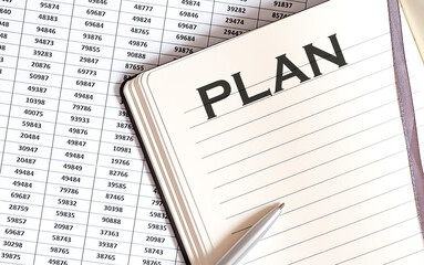 Business concept, on the table a notepad with the text of the PLAN
