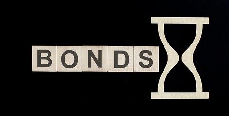 BONDS word from wooden blocks on the black background