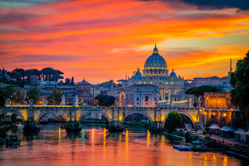 Sunset view of old Sant' Angelo Bridge and St. Peter's cathedral in Vatican City, Rome.Italy