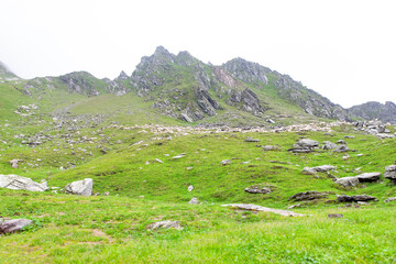 Green Residual Mountains in the Foggy Morning