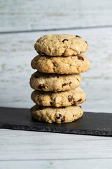Fototapeta na wymiar Homemade oatmeal cookies stacked on a white wood - healthy food - easy recipes