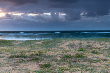 Moody morning bay seascape with rain clouds