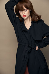Luxurious woman black coat attractive appearance rejoicing studio 