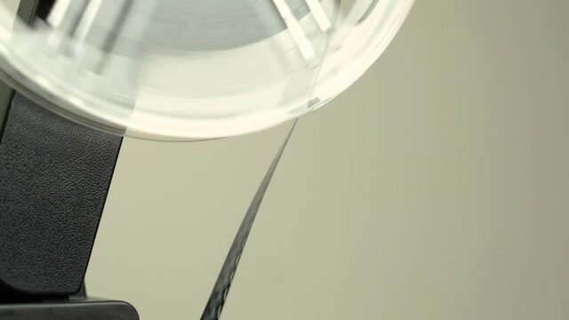 Super 8 cine film projector in operation. Close up shot of wheel with film