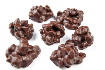 Round sweets with milk chocolate on a white background