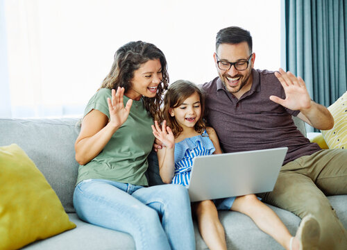 child daughter family mother father together girl  home video call online laptop conference quarantine