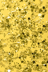 Christmas festive banner background: confetti with sparkling glitter and stars on blue background. Festive and bright. Illuminating and Ultimate gray Pantone color of the year 2021
