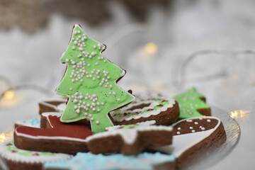 Homemade Gingerbread cookies with Christmas decorations. New year decorations and lights with a gingerbread cookies