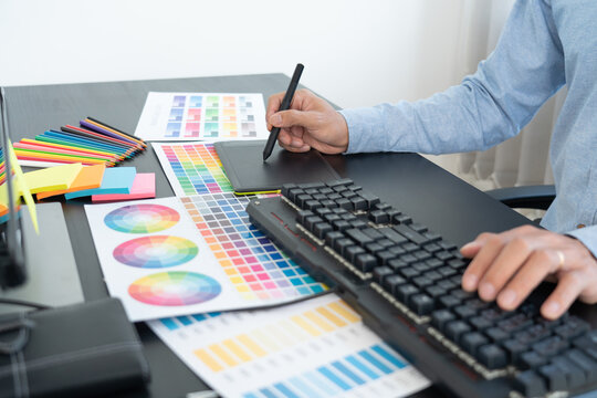 interior designer or creative graphic designer working on project architectural with colour samples with work tools and equipment for selection in office