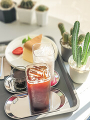 Table set for ice americano and ice chocolate milk served with home made cheese cake, Afternoon tea.