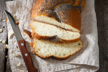 Poppy seed bun. Bread with poppy seeds on a wooden background. Homemade cakes with poppy seeds. Top view