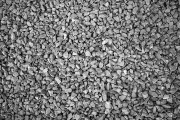 evocative black and white image of texture of pebbles on a beach