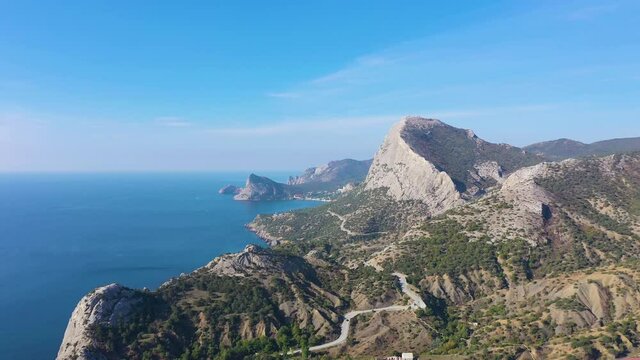 Mountain Sokol and Capchik Cape on a Sunny Day. Black Sea. Crimea, Russia. Aerial View. Drone Flies Sideways and Upwards