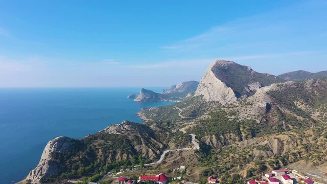 Mountain Sokol and Capchik Cape on a Sunny Day. Black Sea. Crimea, Russia. Aerial View. Drone Flies Forward