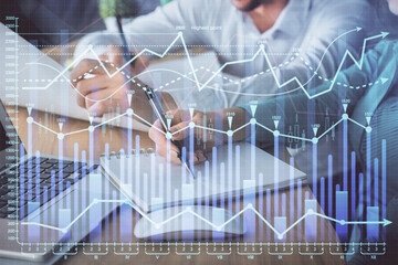 Double exposure of forex chart drawing over people taking notes background. Concept of financial analysis