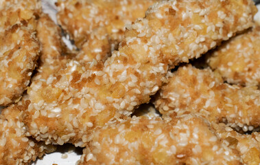Pieces of fried chicken with sesame seeds. Delicious food