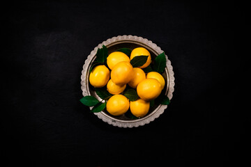 Fresh  lemons on dark stone background. Top view.
