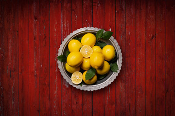 Fresh  lemons on red rustic  background. Top view.