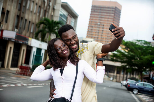 portrait of a happy young couple with mobile phone.