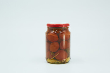 Canned tomatoes in the skin in a glass jar. Home canning.