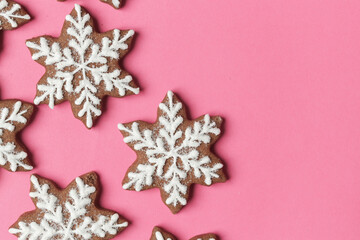 Snowflake gingerbread cookies on pink background.