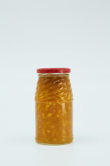 Canned sauce or jam from various products in a glass jar. Home canning.