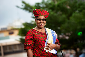 close up of a beautiful mature african woman in traditional clothes, happy.