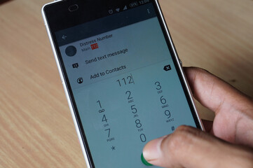 Thrissur, Kerala, India - 12-06-2020: Indian Emergency number 112 dialing on a phone