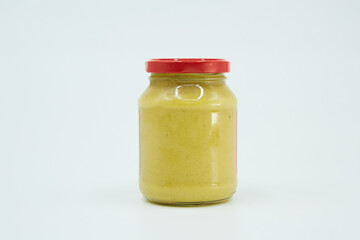 Canned mustard in a glass jar. Home canning.