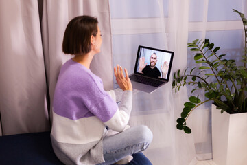 Woman at home facetime video call her friends husband boyfriend, chatting online from laptop, social distance  