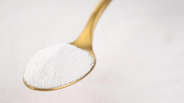 collagen powder in golden spoon and collagen powder background