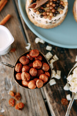 Filtered image of hazelnuts in a brass bowl on a rustic background. Hazelnuts close-up on the table.