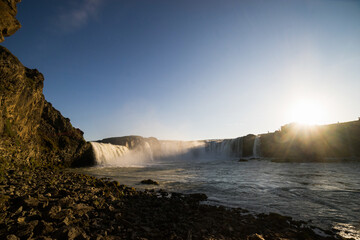 sunny waterfall in iceland 