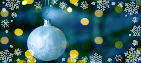  Christmas advent holiday background banner - White Christmas tree ball with ice crystals hang on green Christmas tree with blue bokeh from golden lights