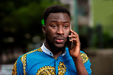 Close-up of a young man communicating on a mobile phone.