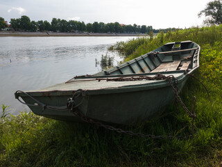 Old boat on shore near Sava river in Bosanski Brod, Bosnia and Herzegovina during sunny summer morning.