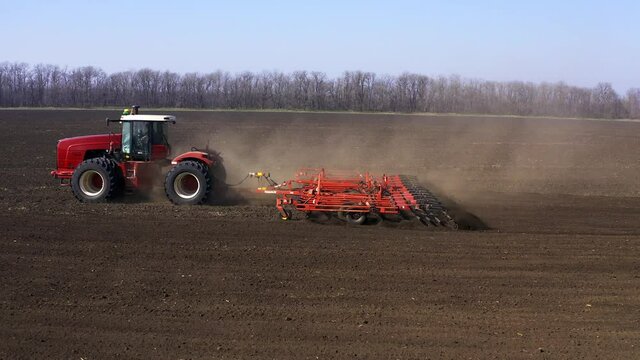 Agriculture. land cultivation. cultivator on a heavy tractor does pre-sowing soil cultivation