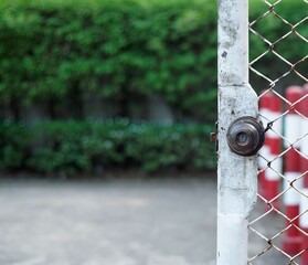 A vintage master key lock very rust of a steel net door of a gass service storage.