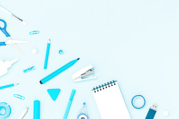 various office and school white and blue stationery on pastel trendy background as corner border. Flat lay with copy space for back to school or education and craft concept