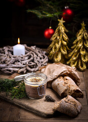 Homemade liver pate in glass jars on rustic festive/christmas table with sourdough bread