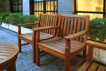 Fototapeta na wymiar Empty wooden chairs in the garden