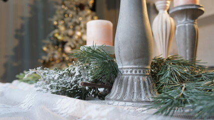 New Year's table, tablecloth, candles, coniferous branches