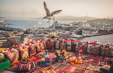Fototapeta premium Great panoramic view of Istanbul from high terrace decorated traditional colorful ornamental pillows