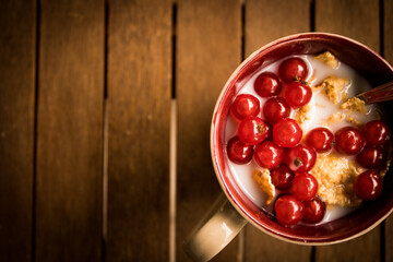 a different kind of breakfast with cereal, milk and ribes