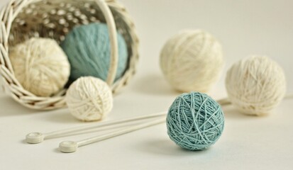 Fototapeta na wymiar Balls of soft white and blue yarn and knitting needles on white background close-up. 