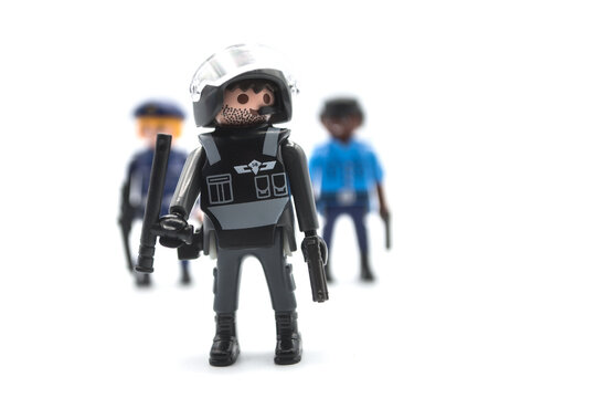 Mulhouse - France - 12 December 2020 - Closeup of playmobil figurines on white background - policemen with anti riot uniform