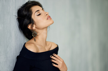 Fototapeta premium portrait of attractive lady with evening make up indoors and evening dress