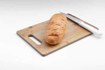 Loaf of bread and knife on a board